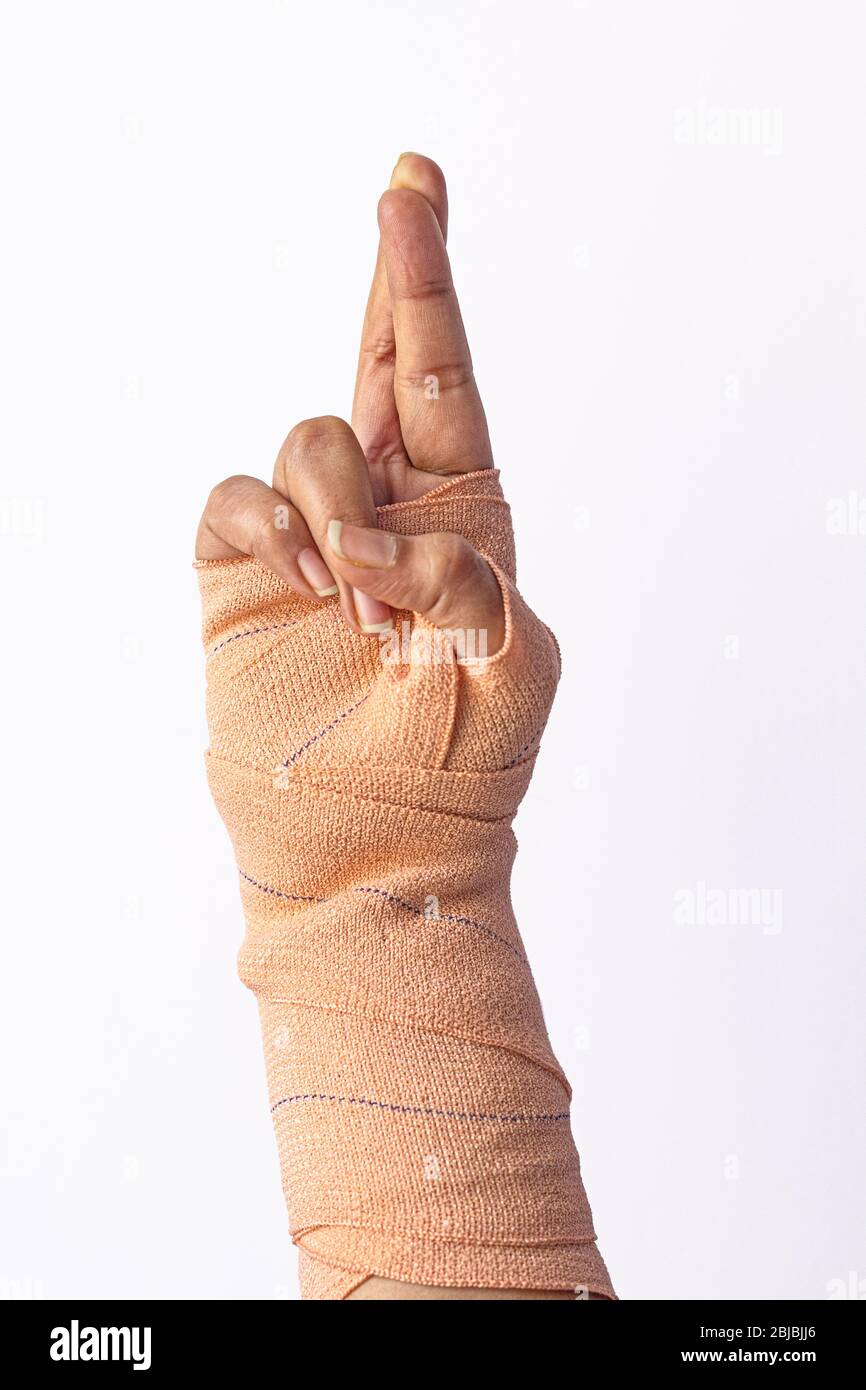 Broken female hand finger crossed gesture Stock Photo