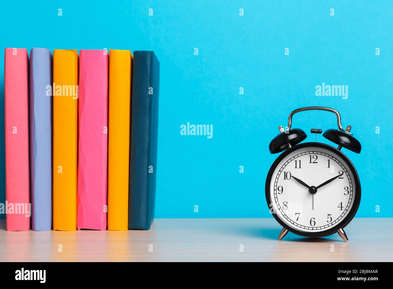 Back to school background with books and alarm clock Stock Photo - Alamy