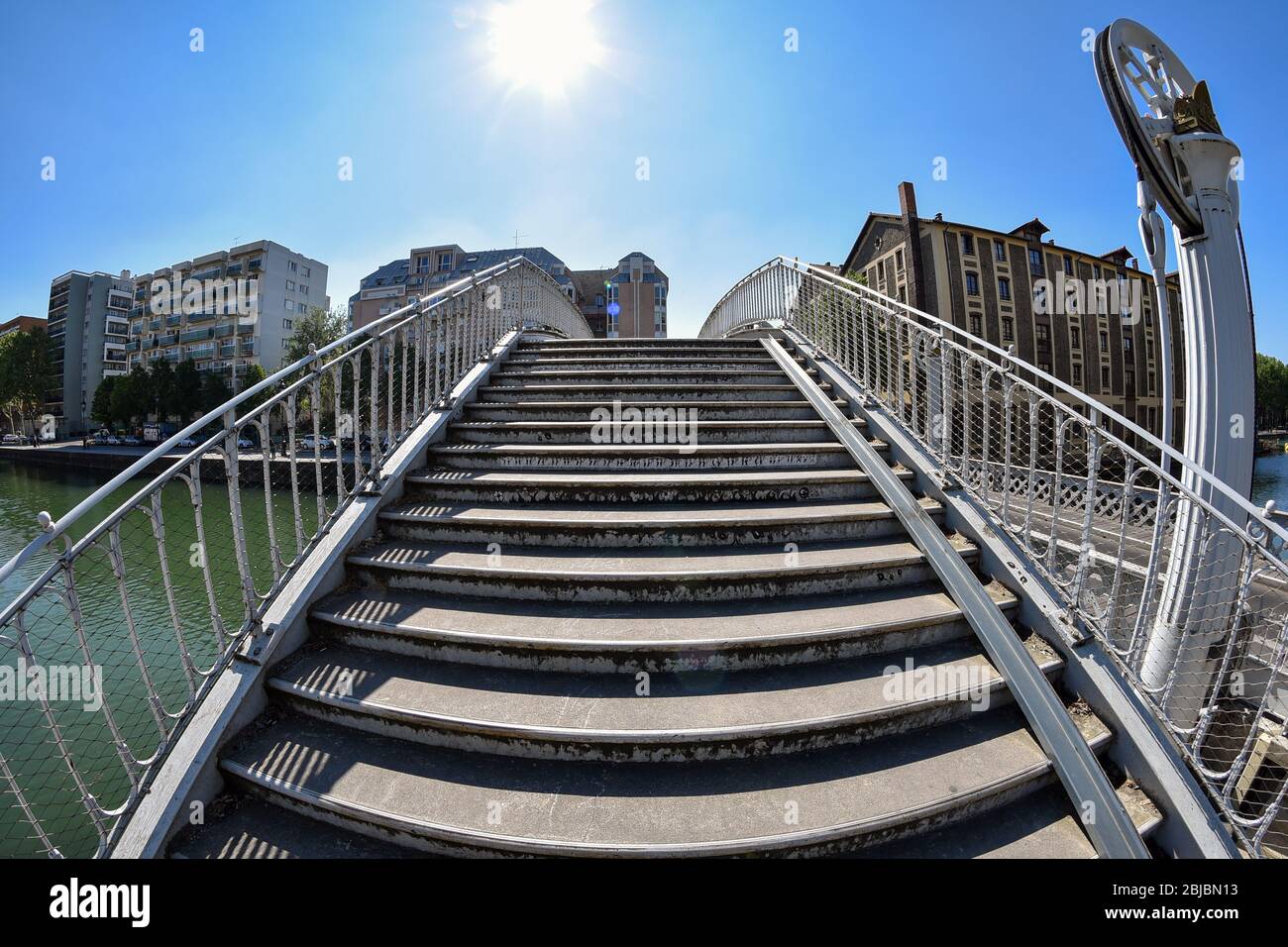 Stairs of the Rue de Crimée lifting bridge (1885) over the Canal de l'Ourcq in the 19th arrondissement of Paris, picture taken with a wide-angle lens. Stock Photo