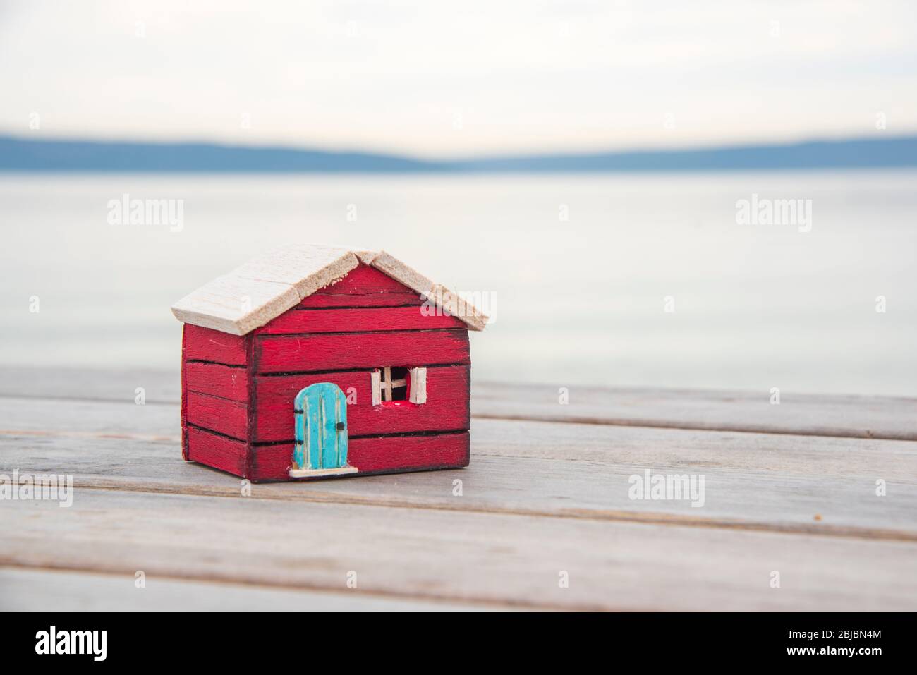 wooden model house on the beach. stay at home stay safe Stock Photo
