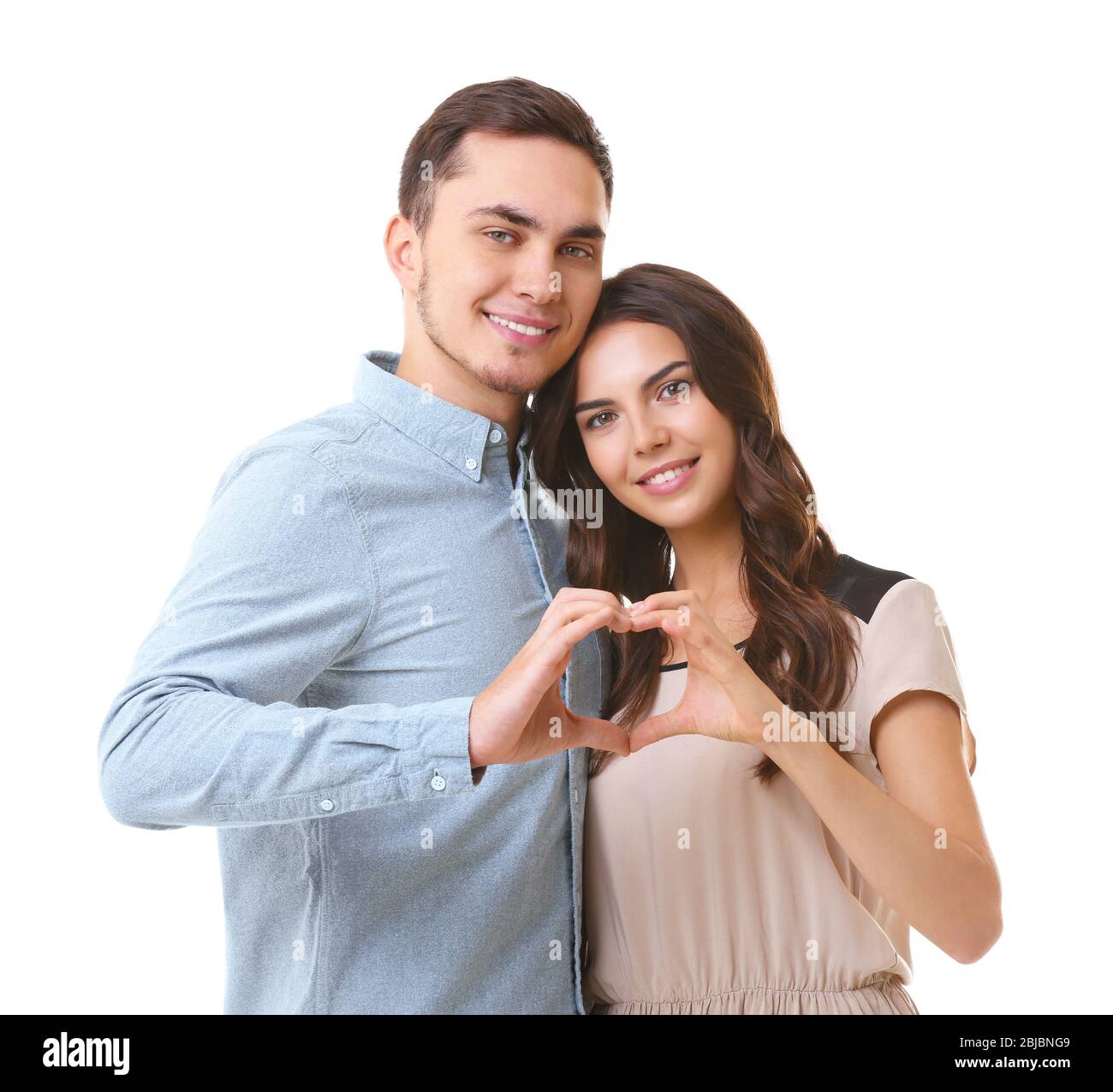 Beautiful couple making heart shape with hands on white background Stock Photo