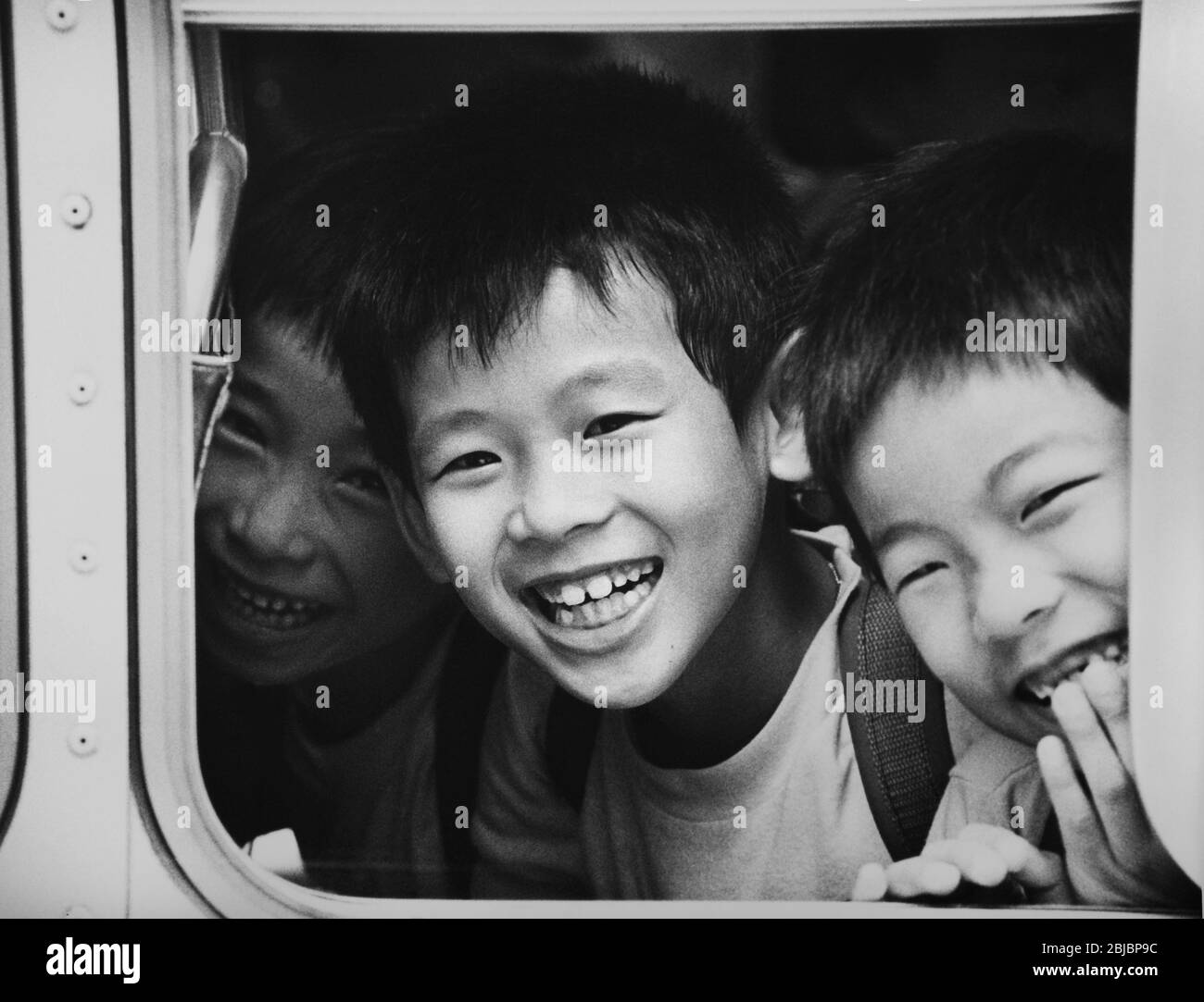 Hong Kong October 1986 Children on school bus, Waterloo Road, Ho Man Tin. The picture is is part of a collection of photographs taken in Hong Kong between September and November, 1986. They represent a snapshot of Daily Life in the Crown Colony eleven years before sovereignty was transferred back to mainland China. Photograph by Howard Walker / Alamy. Stock Photo