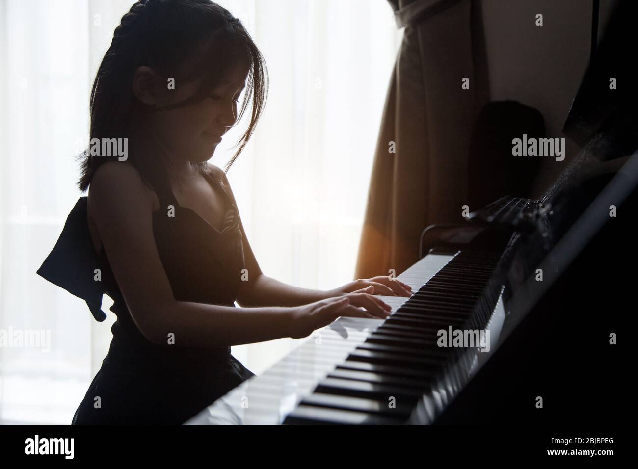 asian girl kids practice play piano for up skill of music ability for future occupation. Stock Photo