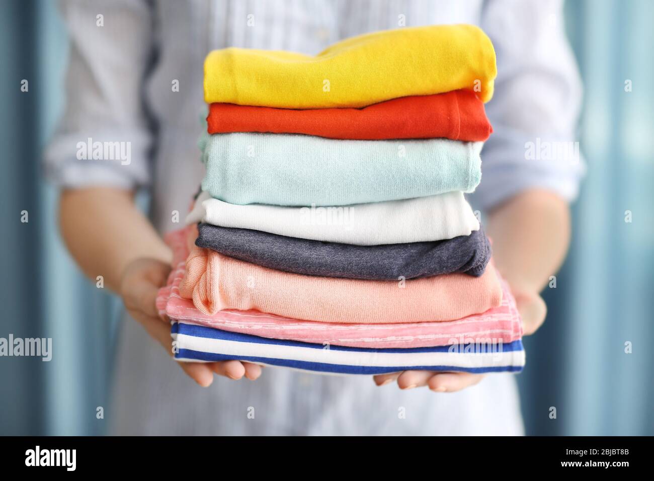 Holding fold clothes hi-res stock photography and images - Alamy