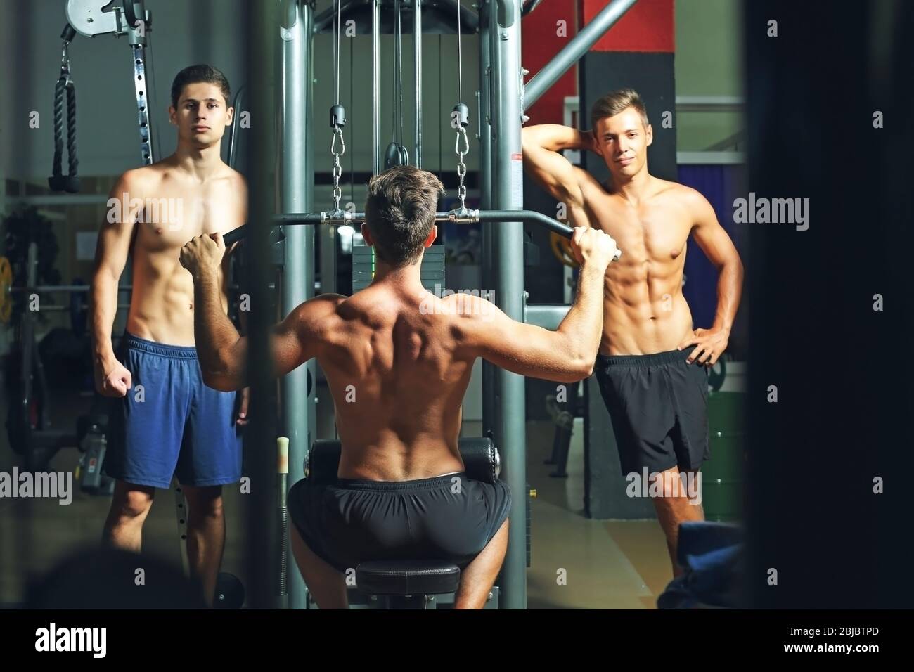 Athletic man training back muscles in gym Stock Photo Alamy