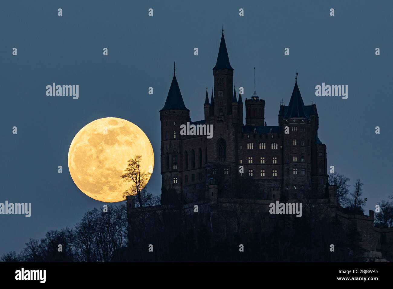 Full moon over Hohenzollern Castle in Southern Germany. Stock Photo