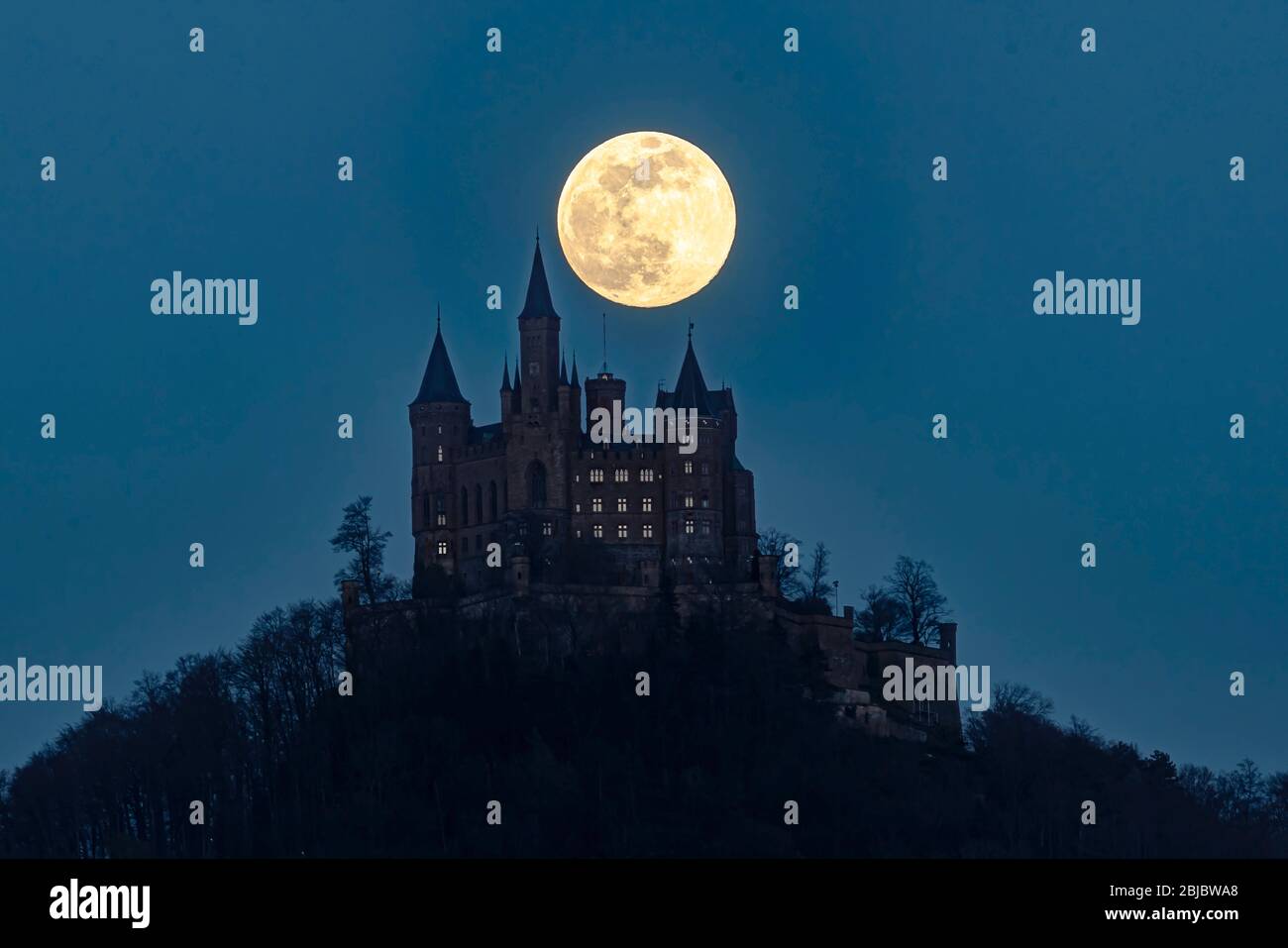 Full moon over Hohenzollern Castle in Southern Germany. Stock Photo