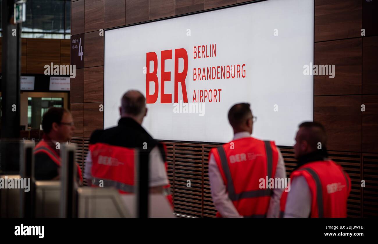 29 April 2020, Brandenburg, Schönefeld: Technicians and workers are on the move in the departure hall of the new Berlin-Brandenburg Willy-Brandt airport. At meetings of the supervisory board and the shareholders' meeting of Flughafen Berlin Brandenburg GmbH, the temporary closure of Tegel Airport will be discussed. Photo: Michael Kappeler/dpa Stock Photo