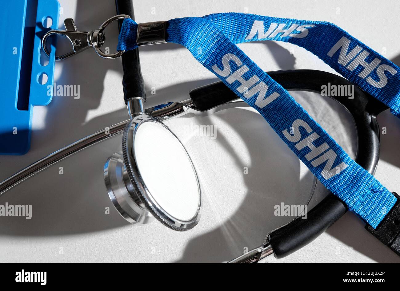 doctor's stethoscope and nhs lanyard on white background Stock Photo