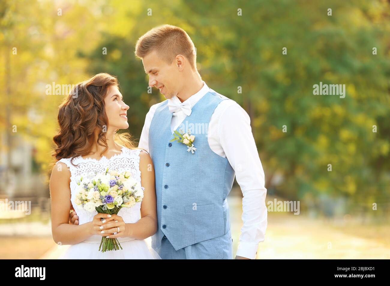 Portrait of beautiful wedding couple on blurred background Stock Photo ...