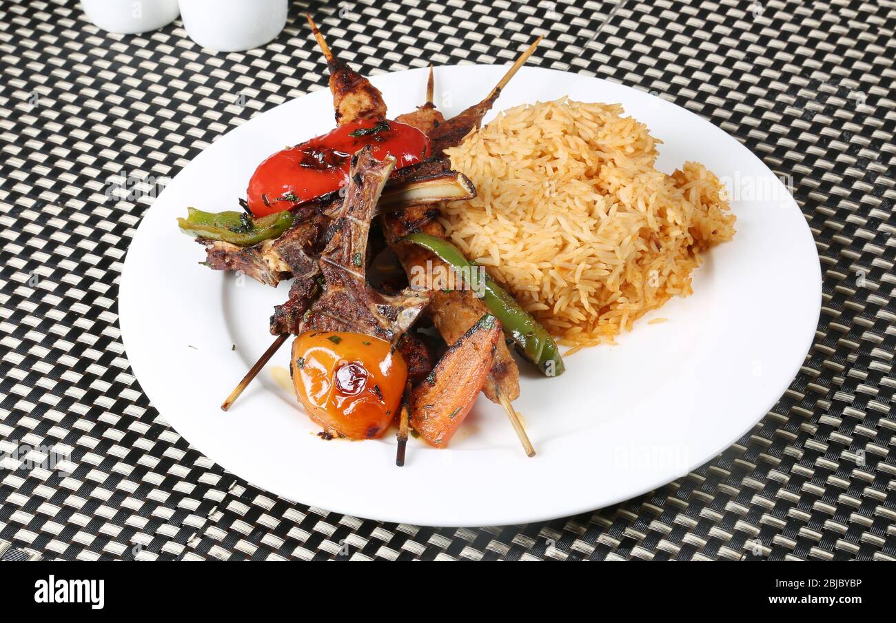 Non veg Meal | Grilled Mutton Chaps, Kebab, Grilled Tomato and Capsicum served with Rice Stock Photo