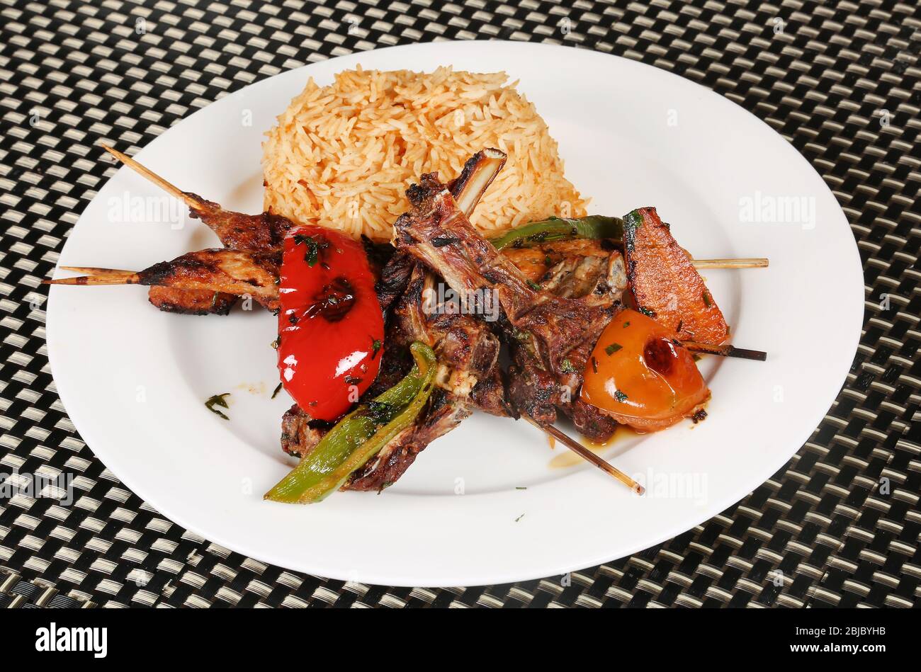 Non veg Meal | Grilled Mutton Chaps, Kebab, Grilled Tomato and Capsicum served with Rice Stock Photo
