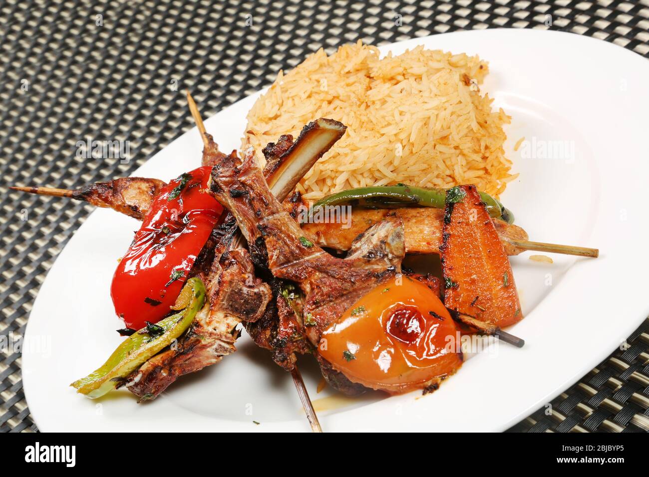 Non veg Meal | Grilled Mutton Chaps, Kebab, Grilled Tomato and Capsicum served with Rice Stock Photo