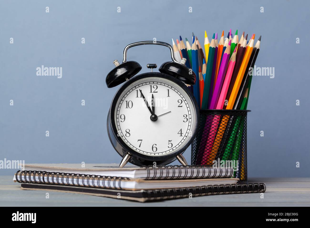 Back to school background with books and alarm clock Stock Photo - Alamy