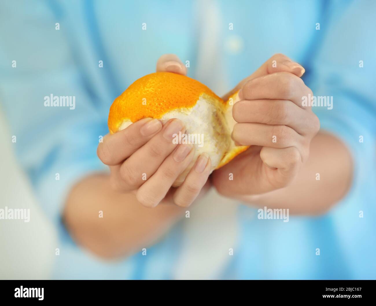 Closeup hands peeling orange fruit hi-res stock photography and images ...