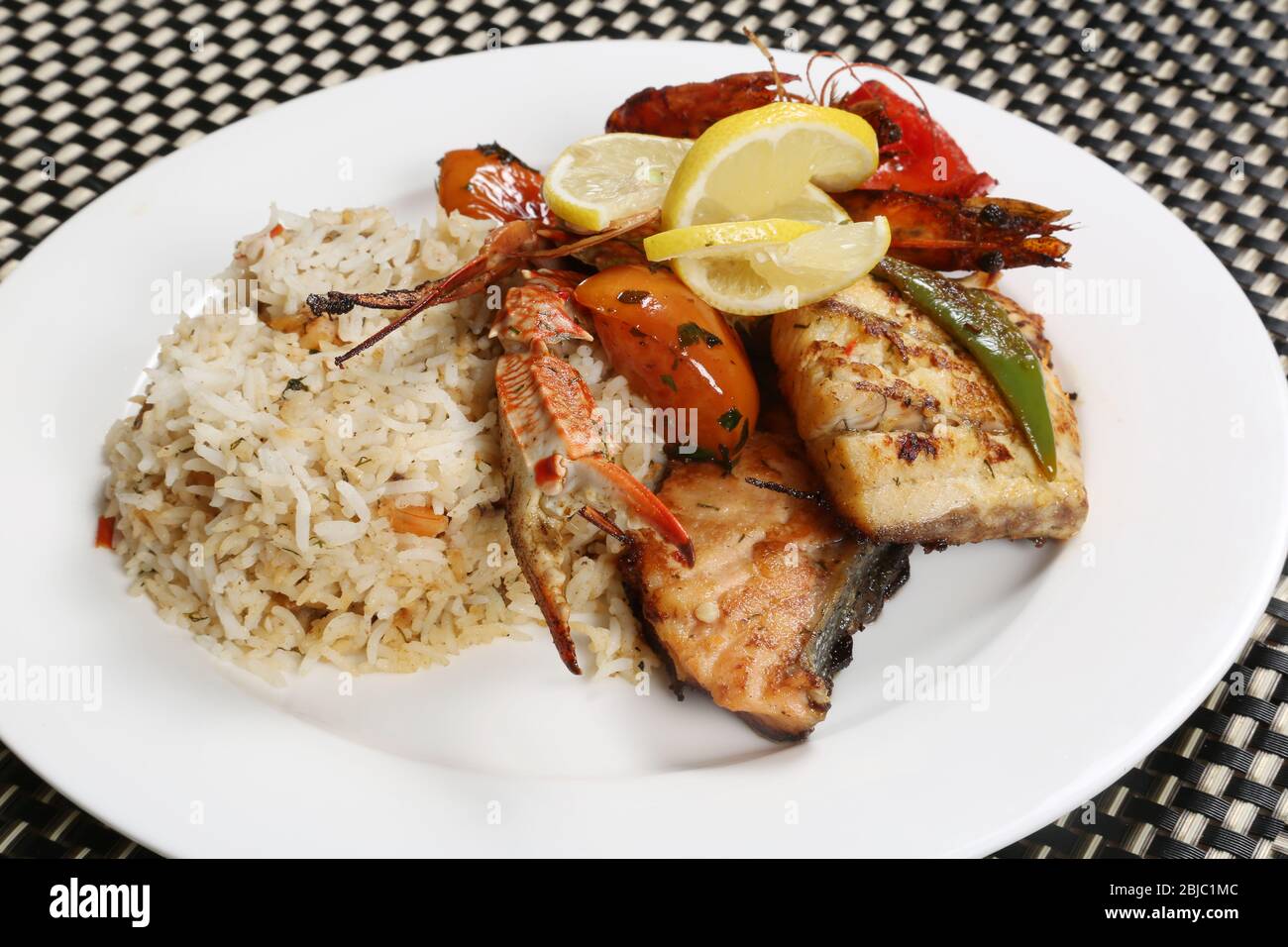 Cooked Healthy Seafood Meal  with Rice and Lemon Slices Stock Photo