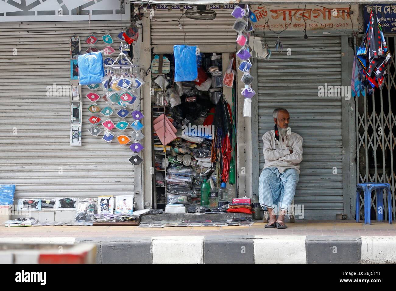 A shopkeeper waiting for a buyer Elephant Road in the capital,as Government call a fourth time increase the general holiday till May 5, 2020, due to C Stock Photo