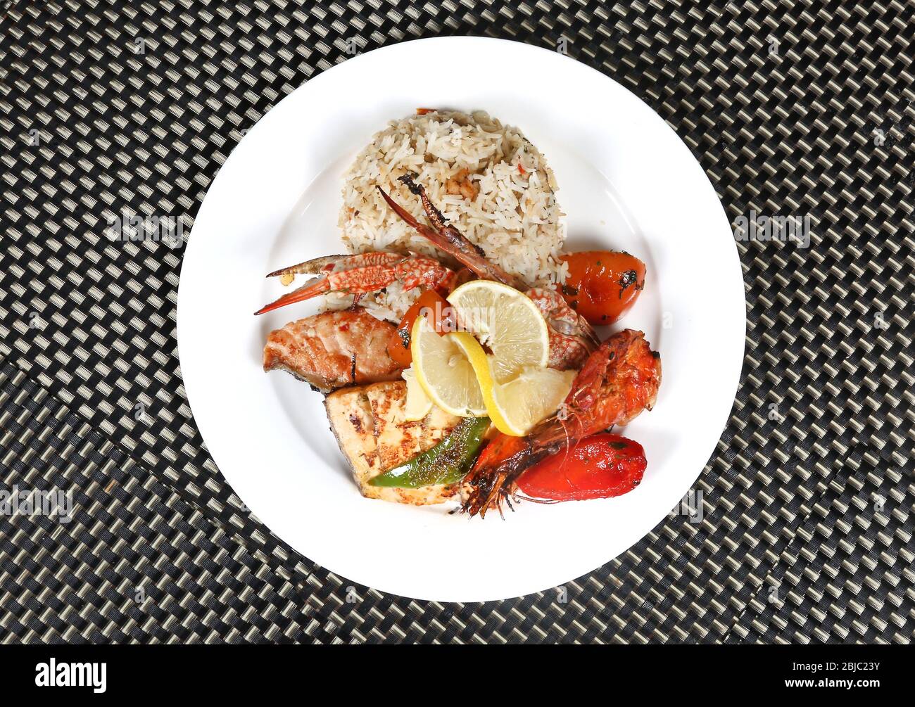 Cooked Healthy Seafood Meal  with Rice and Lemon Slices Stock Photo