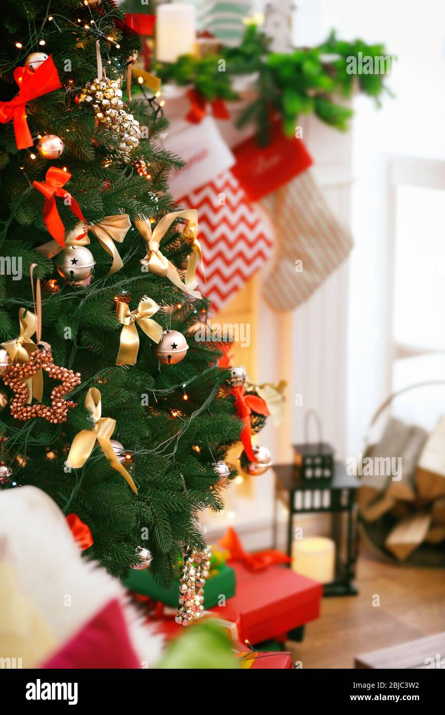 Close up view of beautiful decorated Christmas tree on blurred ...