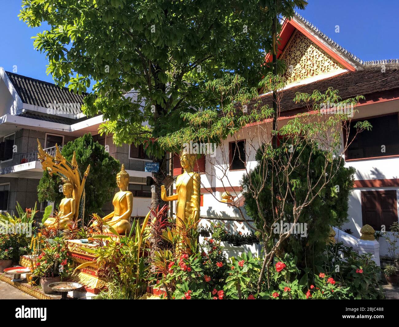 Three Golden Buddha Statues of Temple in Luang Prabang, Laos Republic Stock Photo