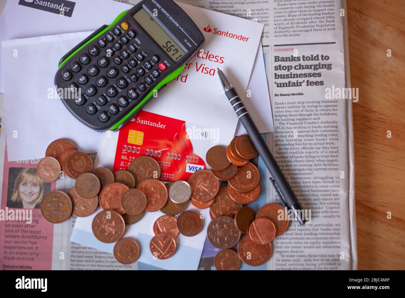 Business & Finance News Concept - Banking Fees for Business under scrutiny.  Calculator, newspaper on office table. Copyspace. UK 2020 Stock Photo -  Alamy