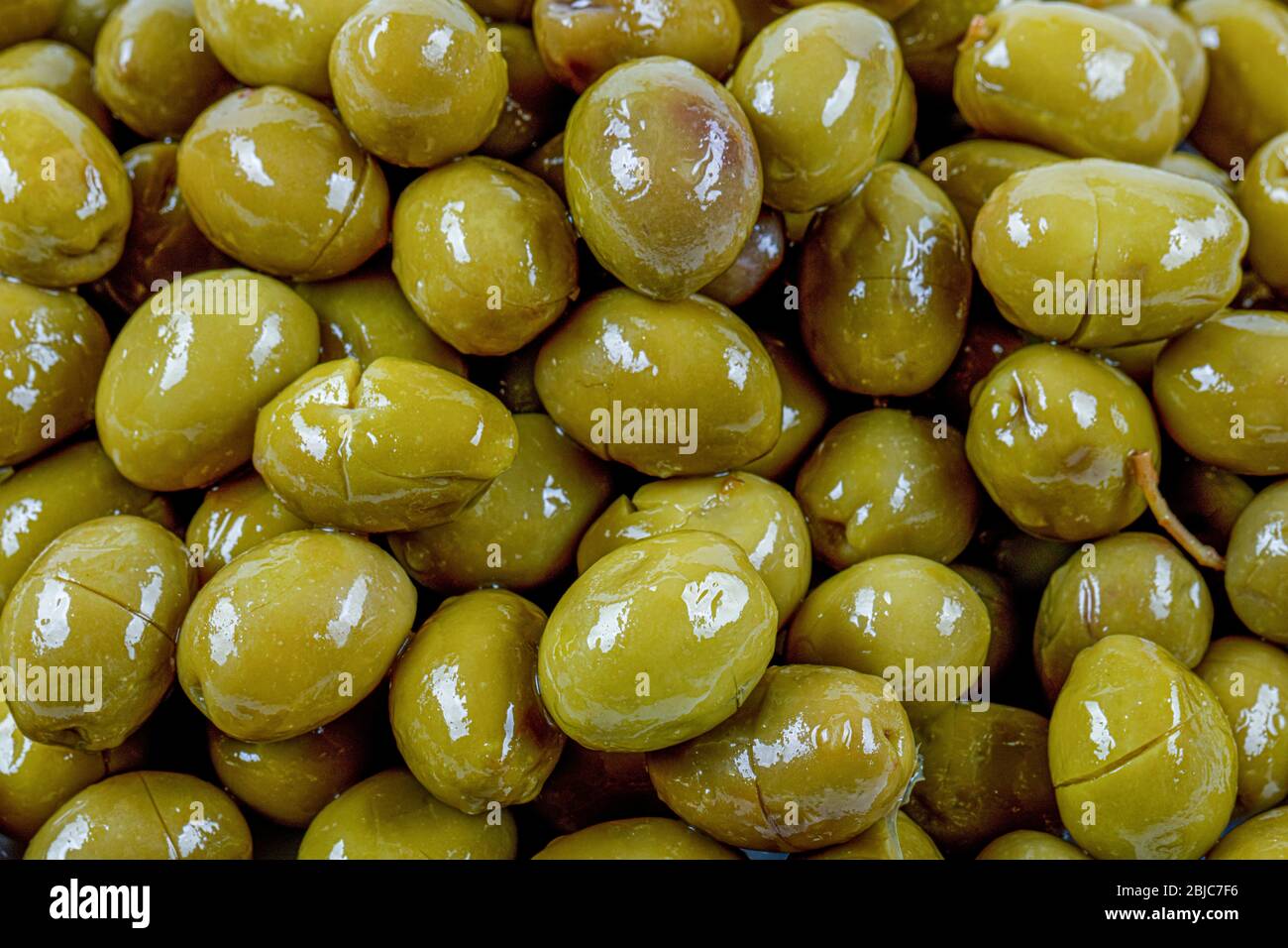 Scratched green olives. Turkish name; cizik yesil zeytin. Brined