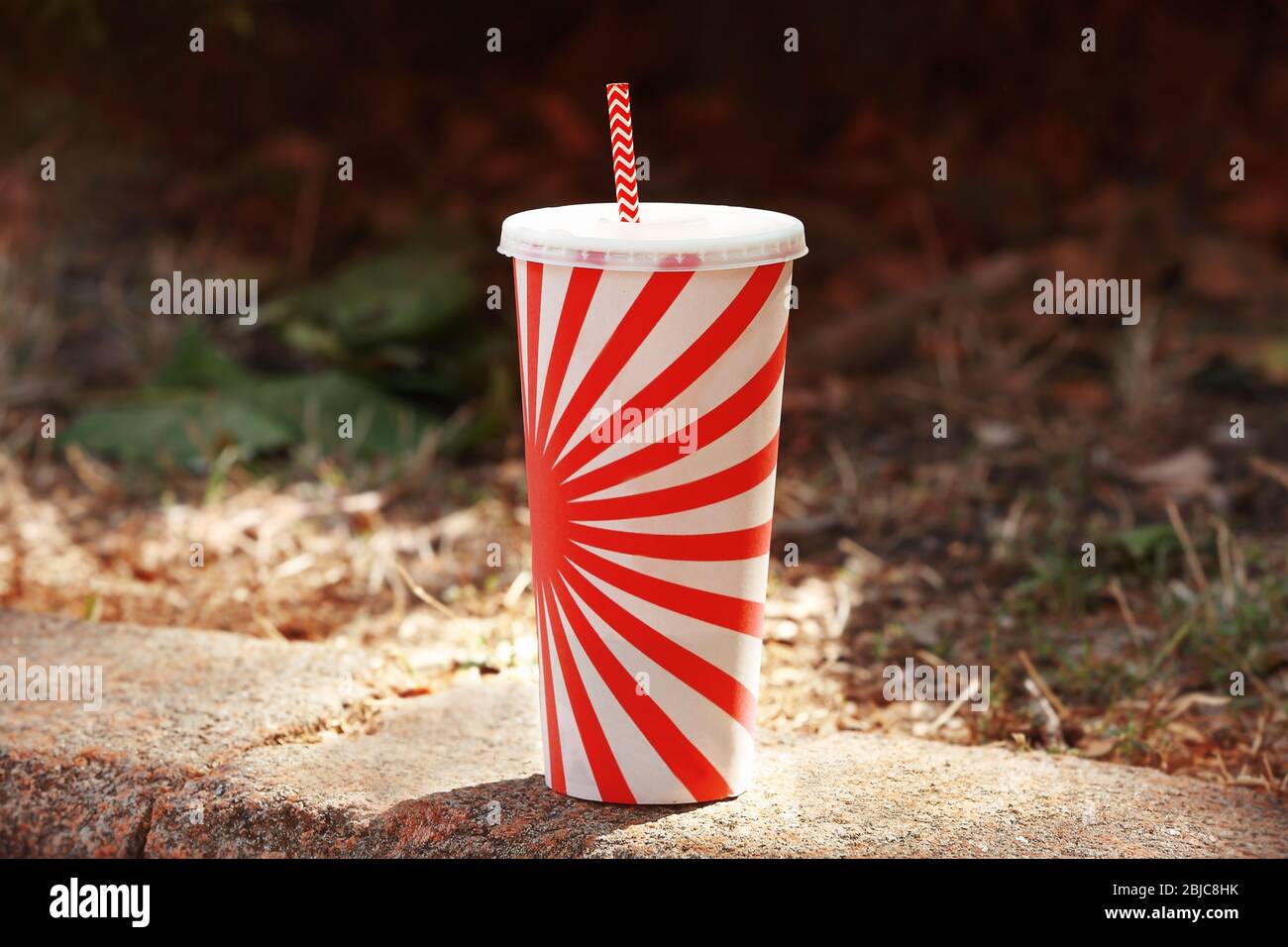 Drink cup with straw on street Stock Photo Alamy