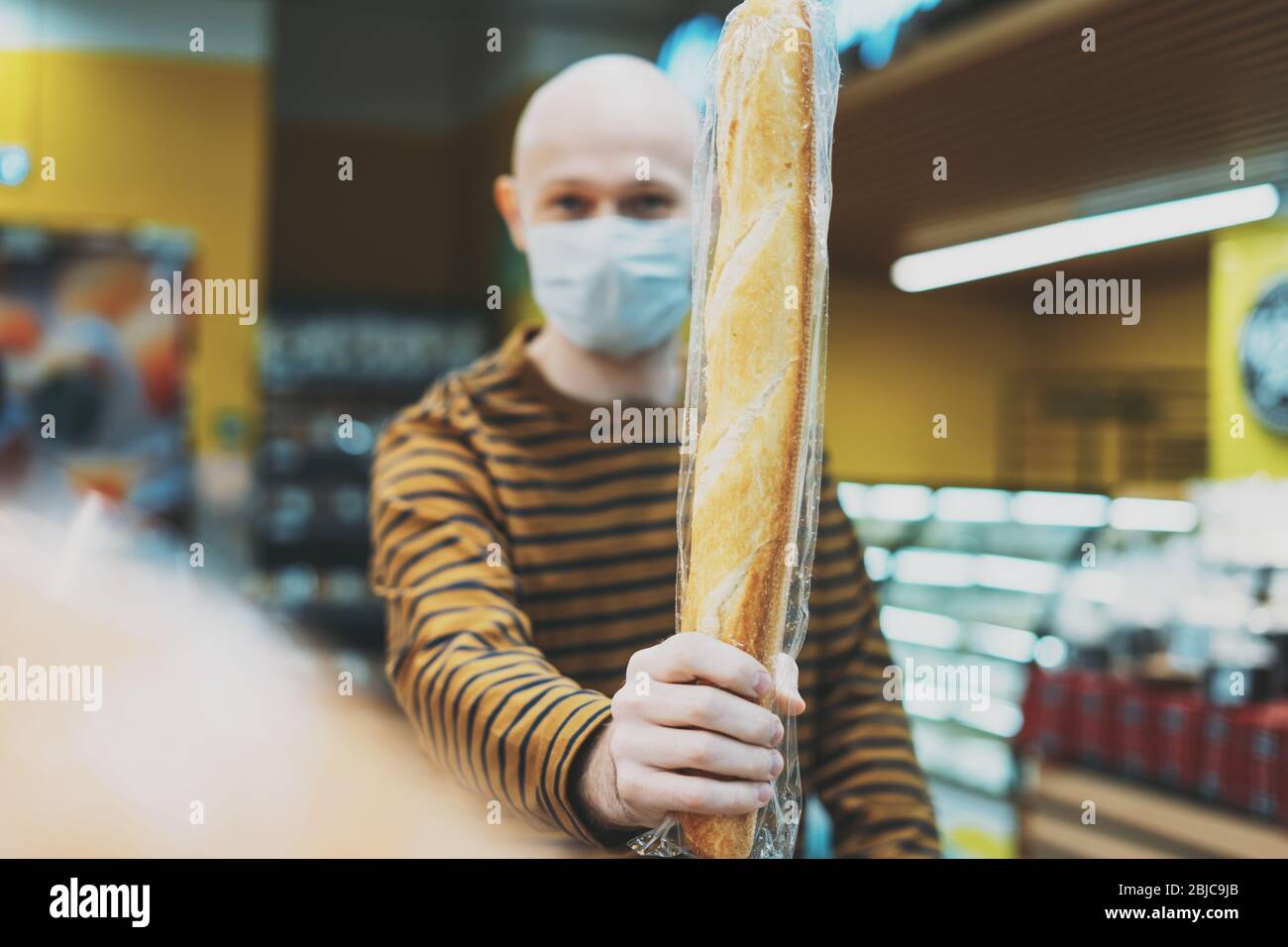 Funny Adult Bald Man In Medical Face Mask With Bread In The