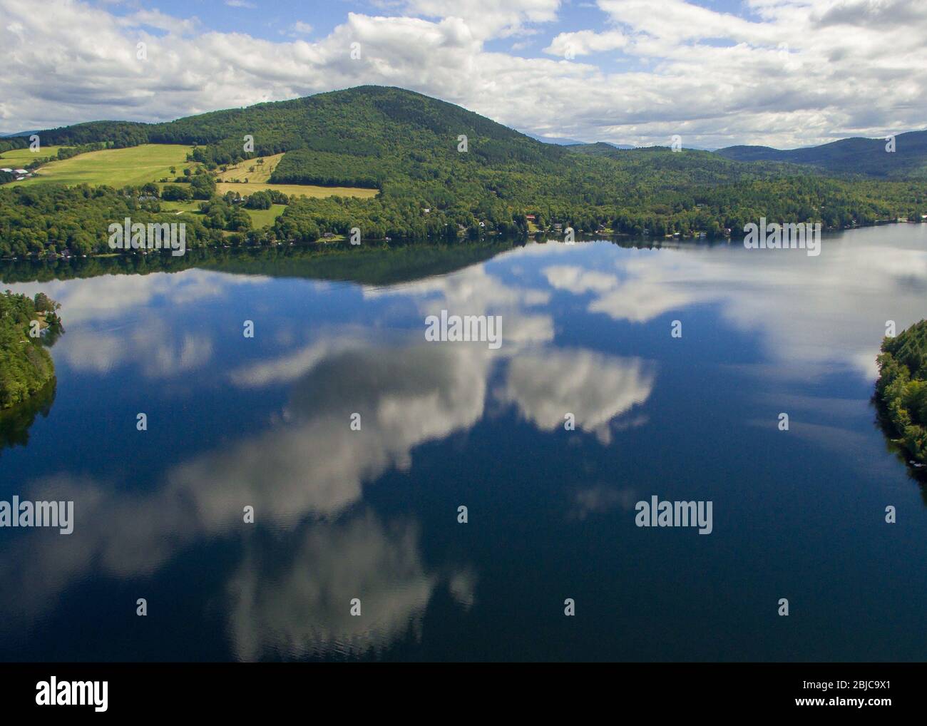 Clouds reflecting on Harvey's Lake, Barnet, VT Stock Photo