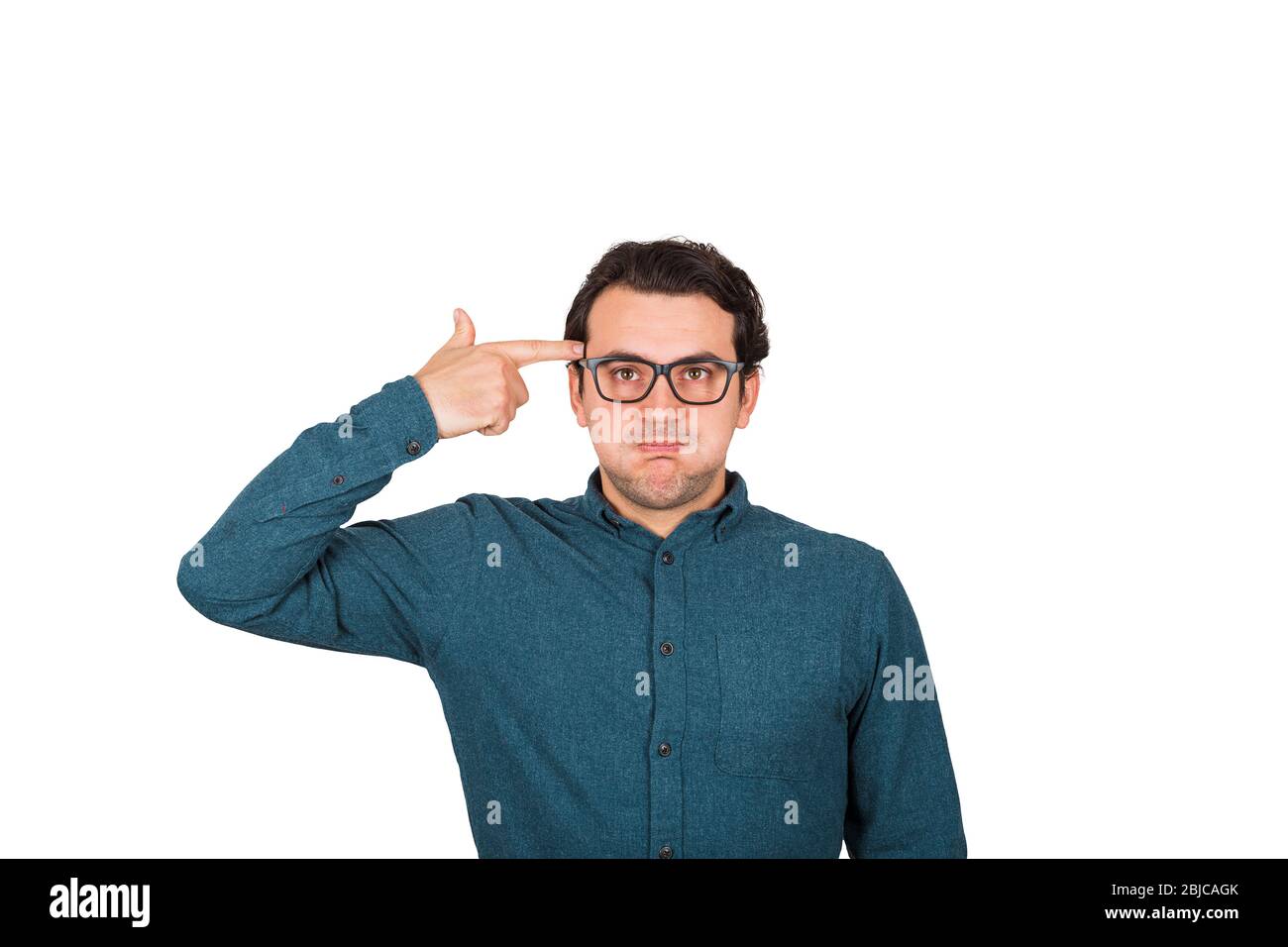 Annoyed businessman headshot himself. Keeps hand to his temple, as gun gesture, punching his head being frustrated. Head shot, displeased face emotion Stock Photo