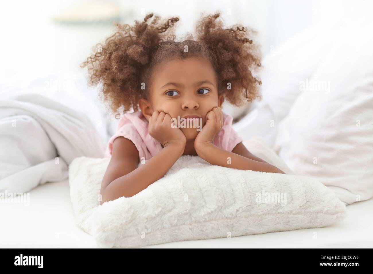 Little African American girl resting in bed Stock Photo - Alamy
