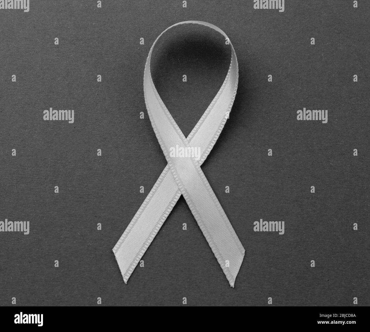 Grey ribbon on color background. Brain cancer, diabetes, asthma concept Stock Photo
