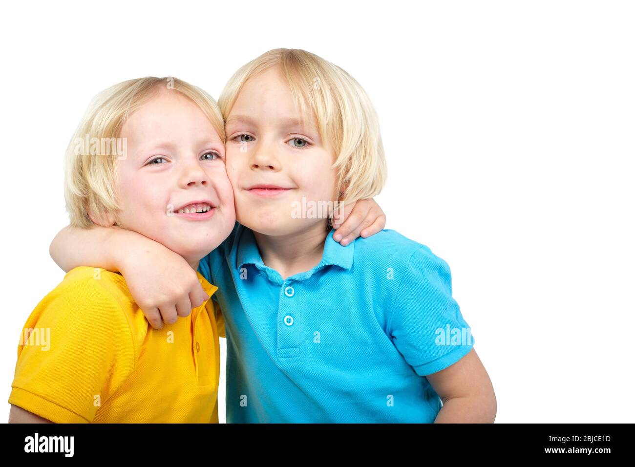 Two caucasian boys brothers posing in studio Stock Photo - Alamy