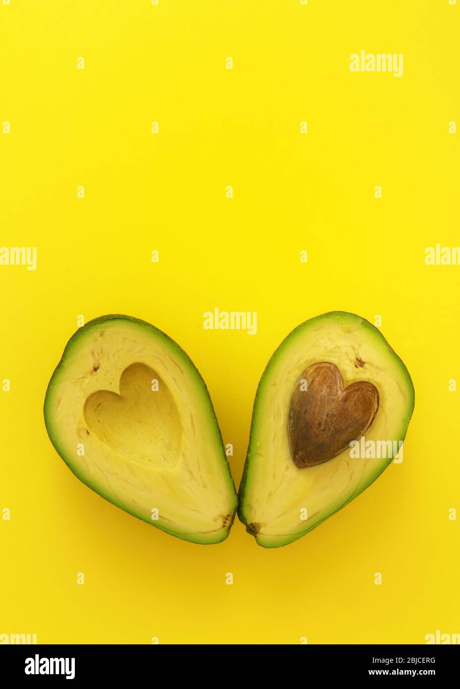 Flat Lay Of Cut In Half Avocado With Seed In Shape Of Heart On Yellow Background Love Forever Inseparable Concept Stock Photo Alamy