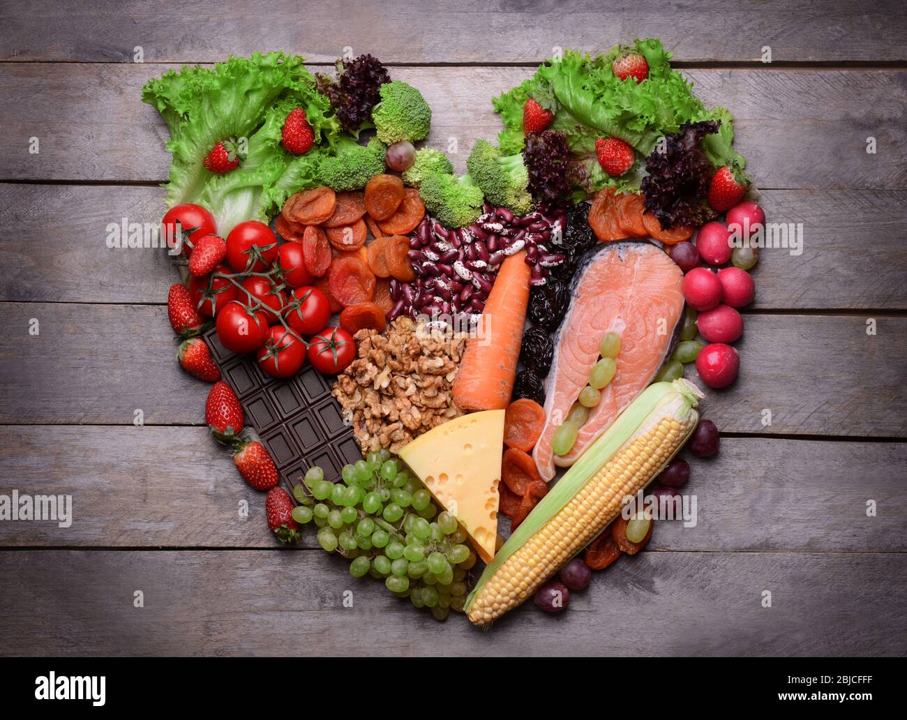 Heart made of healthy food on wooden background Stock Photo - Alamy