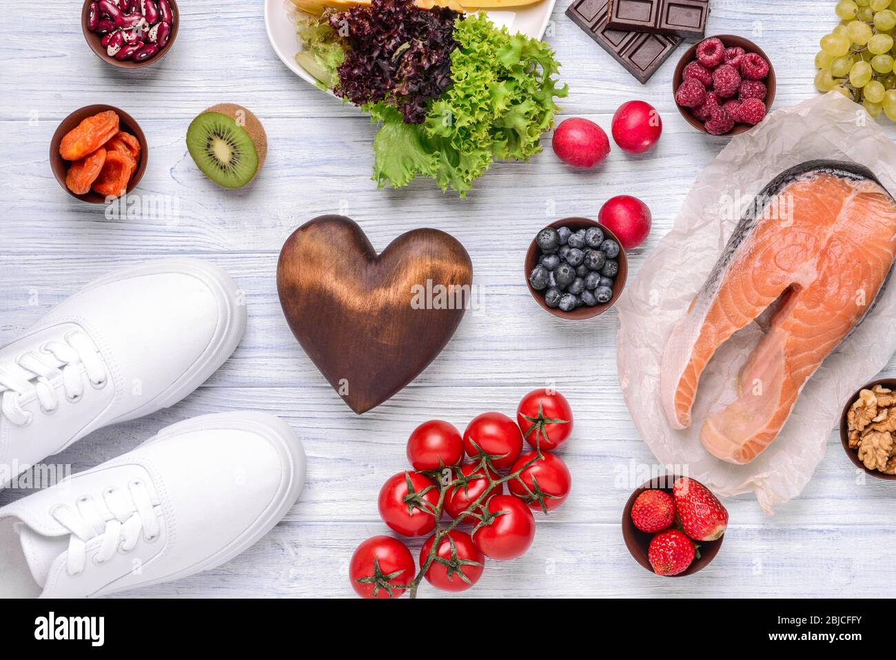 Heart and healthy food on white wooden background Stock Photo - Alamy