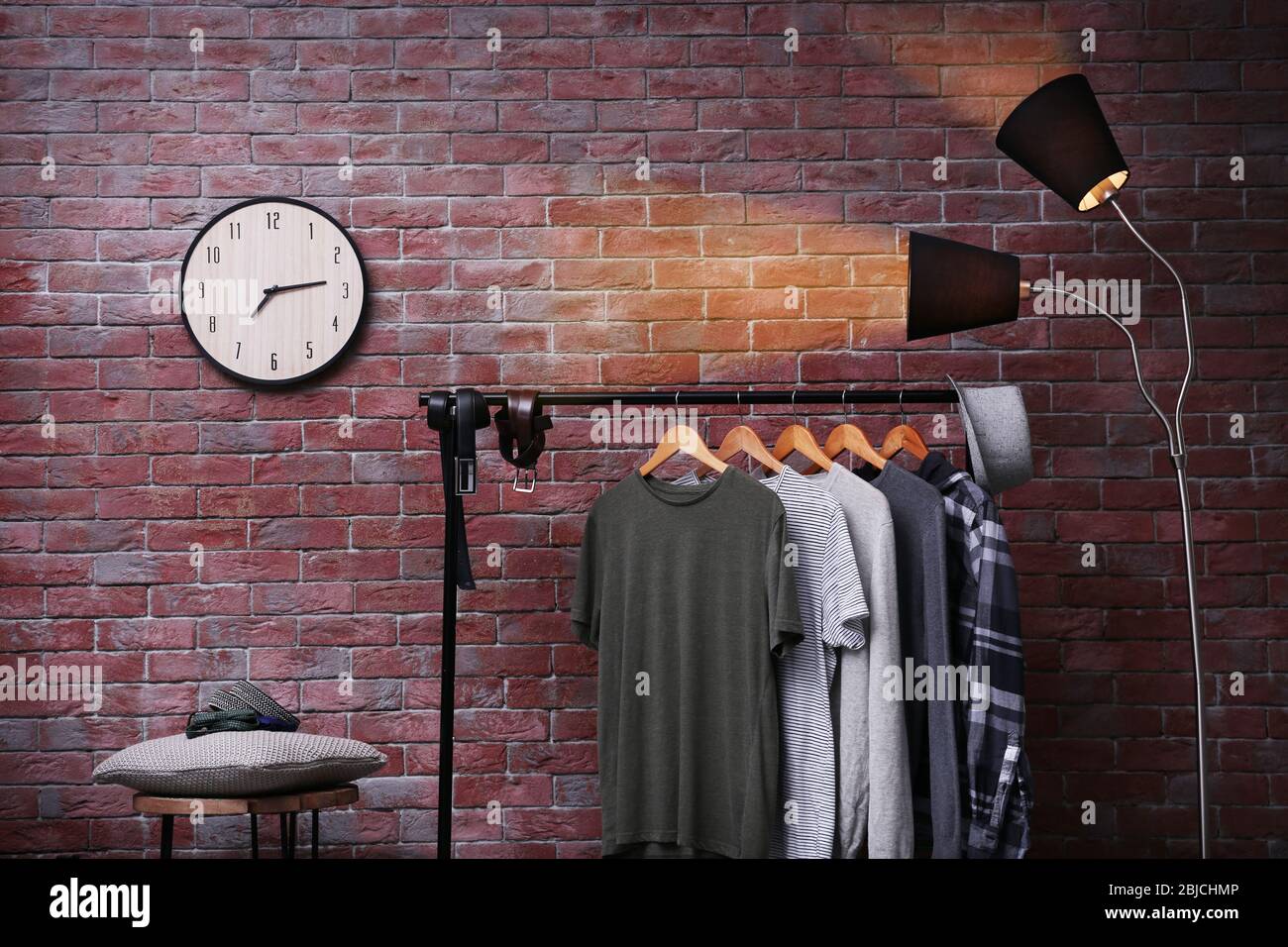 Casual stylish shirts on hanger stand in room Stock Photo