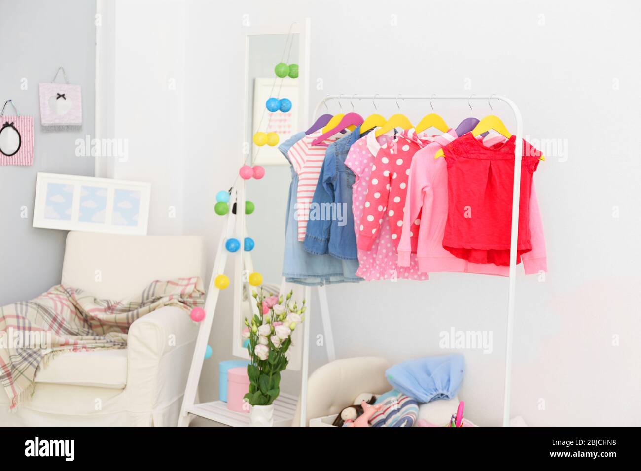 Children clothing on hanger stand in dressing room Stock Photo