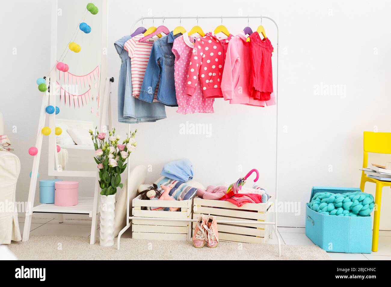 Children clothing on hanger stand in dressing room Stock Photo