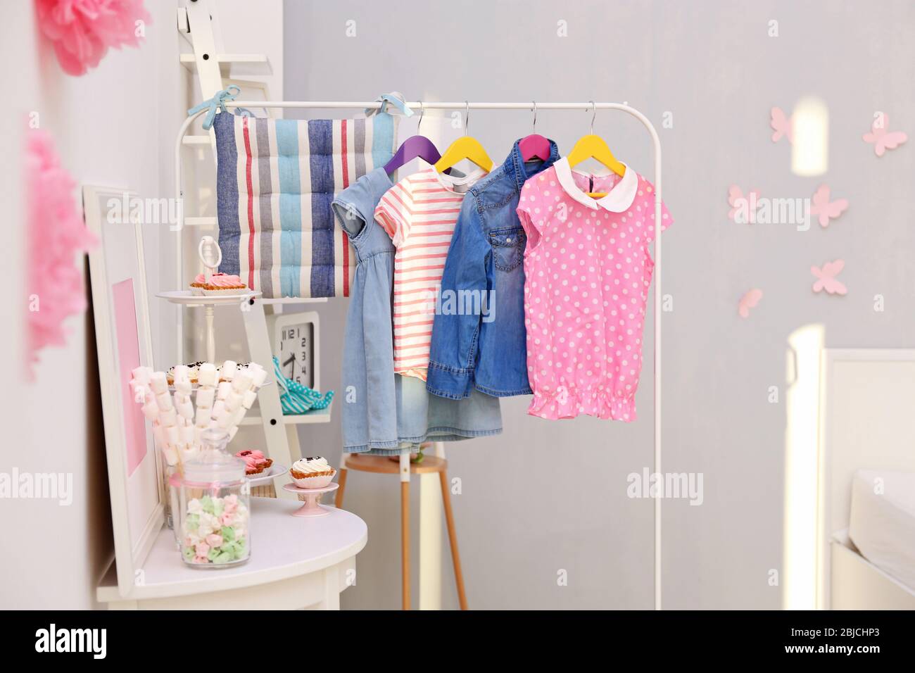 Children clothing on hanger stand in dressing room Stock Photo