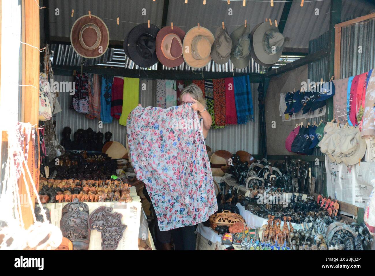 European woman admiring crafts and scarves at curio shop, Pilgrims Rest, Mpumalanga South Africa Stock Photo