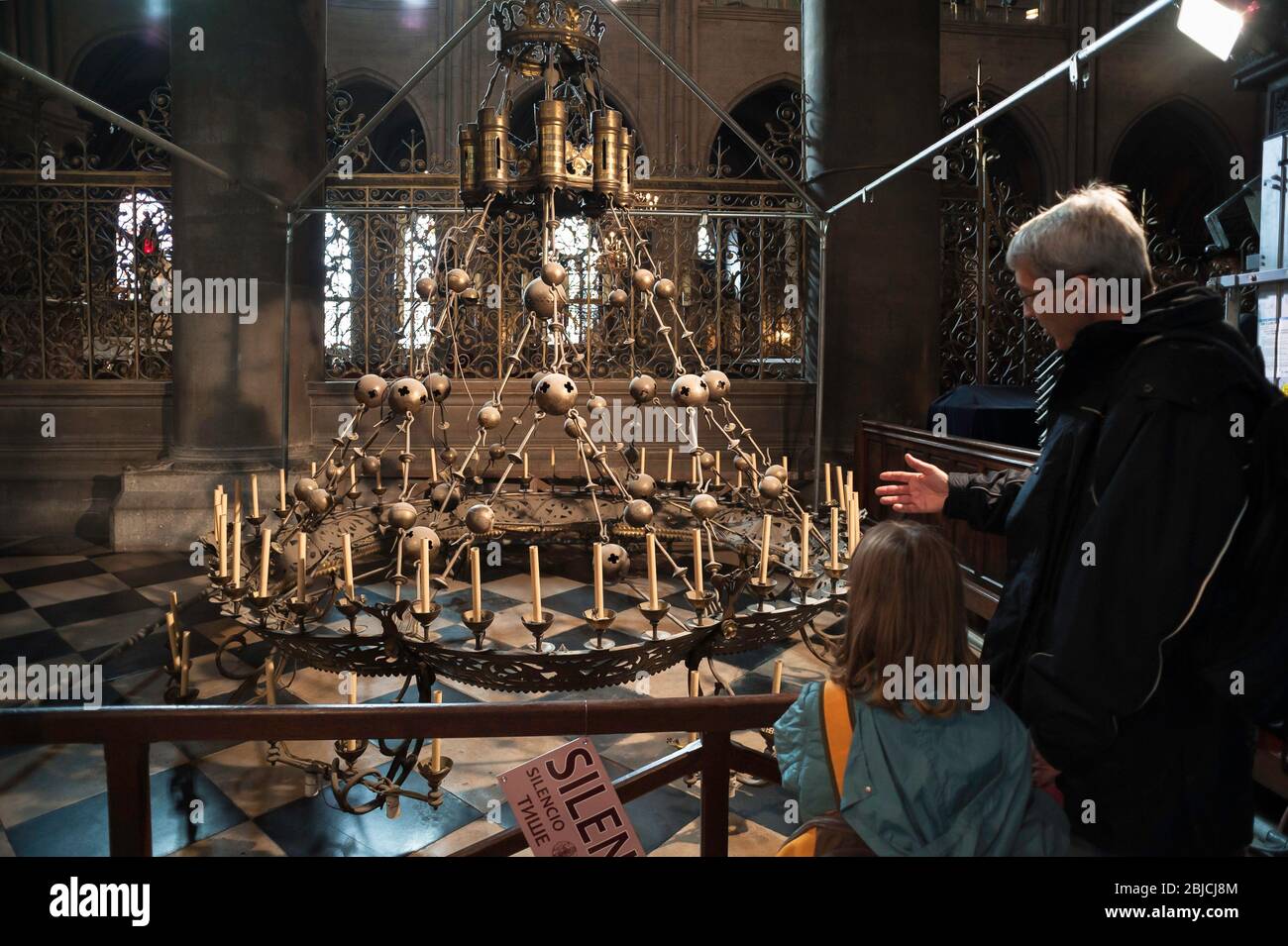 Chandelier Notre Dame Cathedral, a father shows his daughter the Great Chandelier or 'Crown Of Light' inside Notre Dame Cathedral, Paris, France Stock Photo