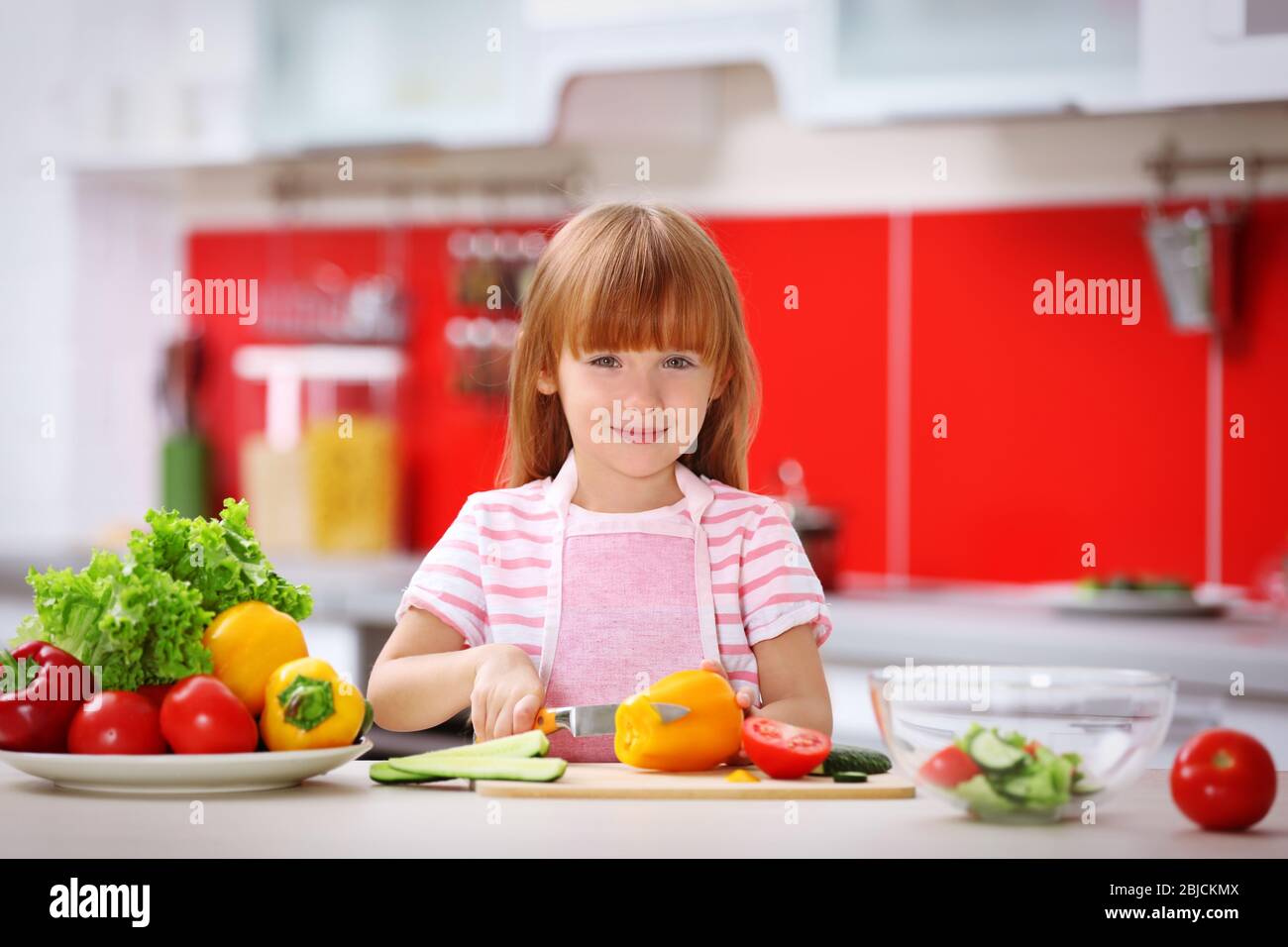 Little girl cooking in the kitchen Stock Photo Alamy