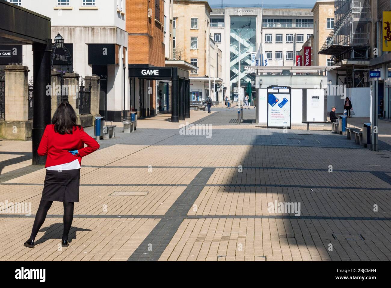 A high street bank employee waits to direct any customers during the coronavirus lockdown Stock Photo