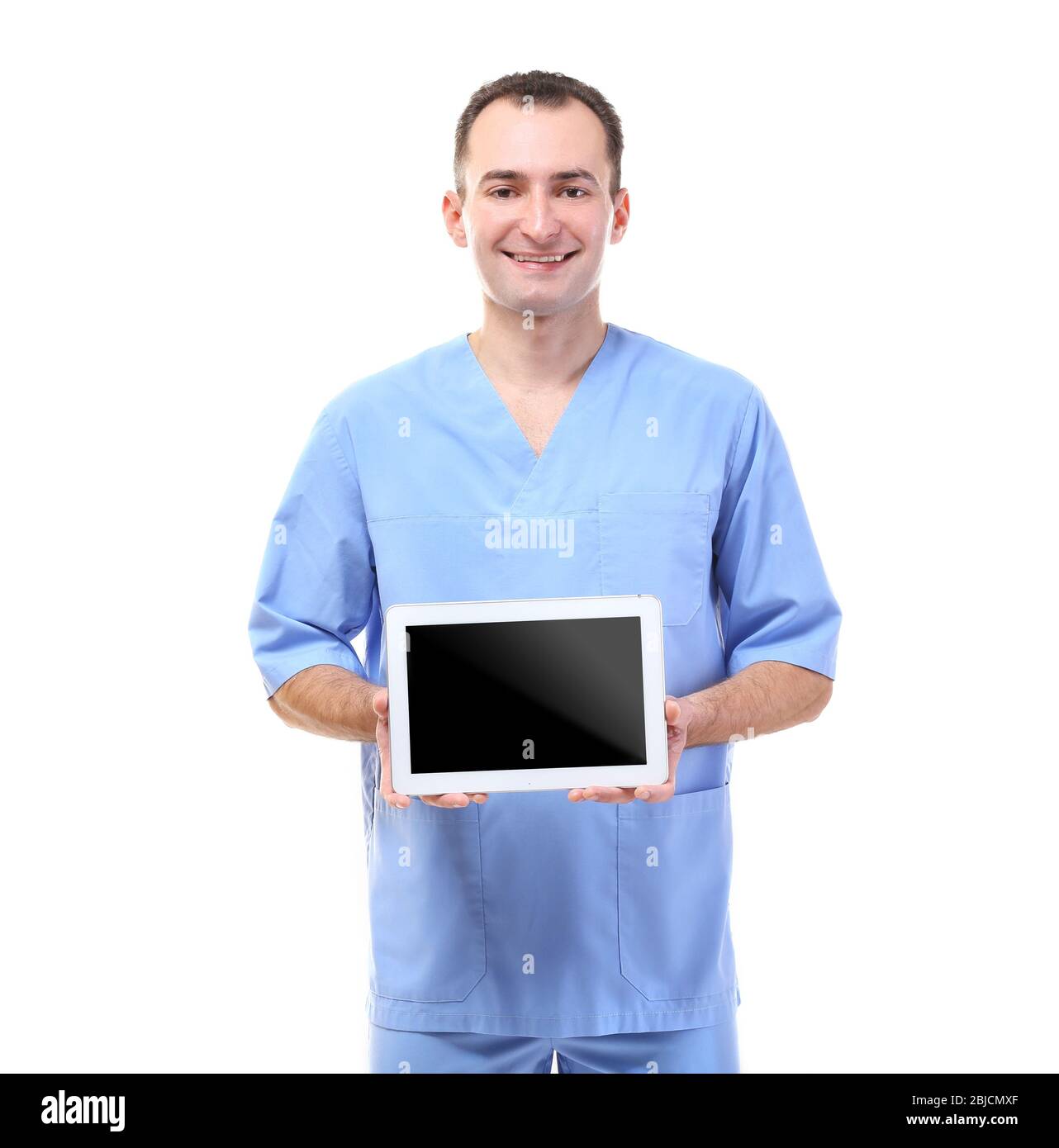 Practitioner in blue uniform holding tablet on white background Stock ...