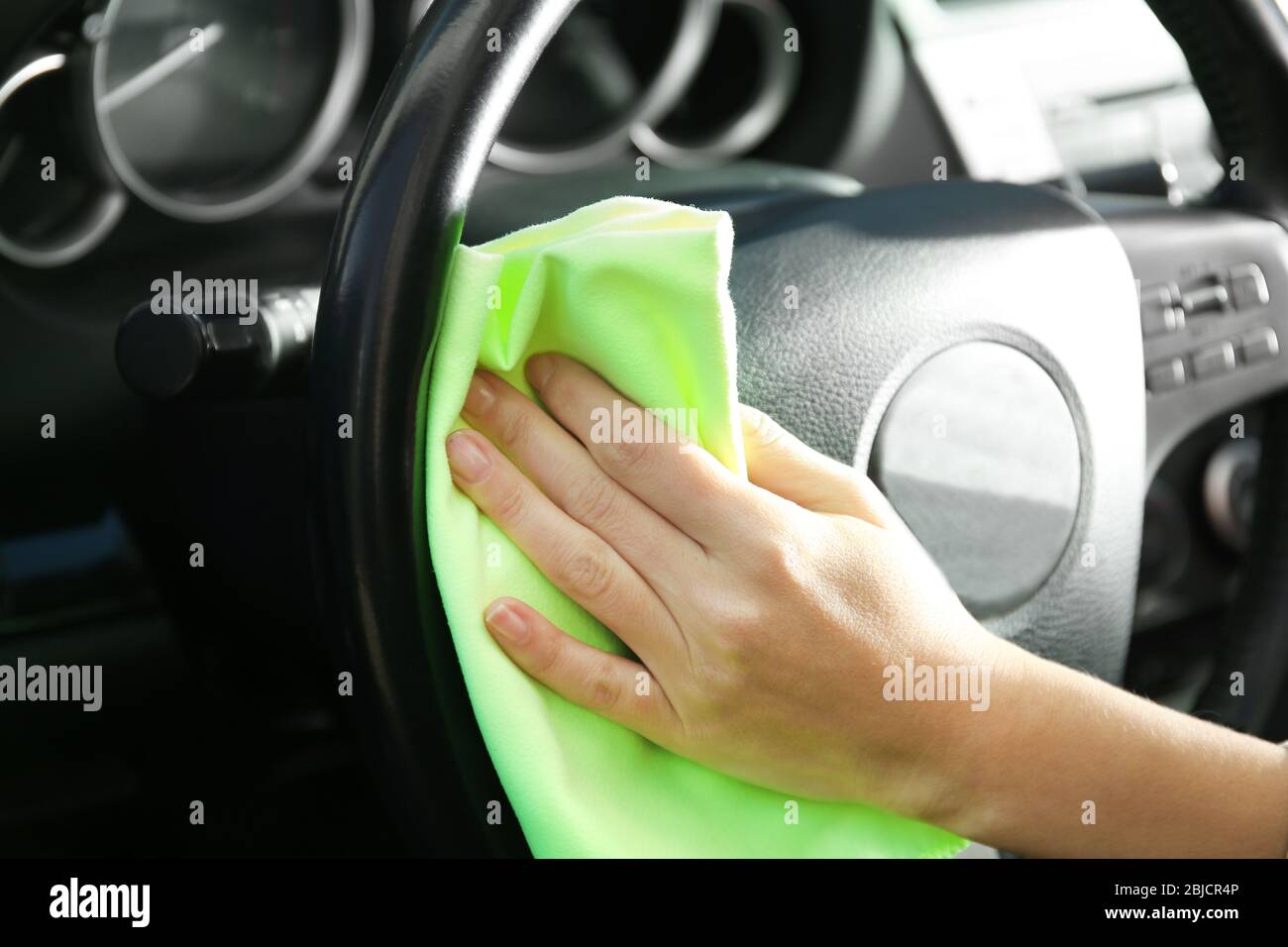 Man wiping interior of luxury car Stock Photo Alamy