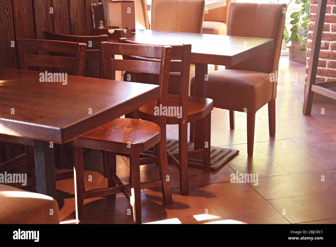 Wooden table and chairs in modern cafe Stock Photo - Alamy