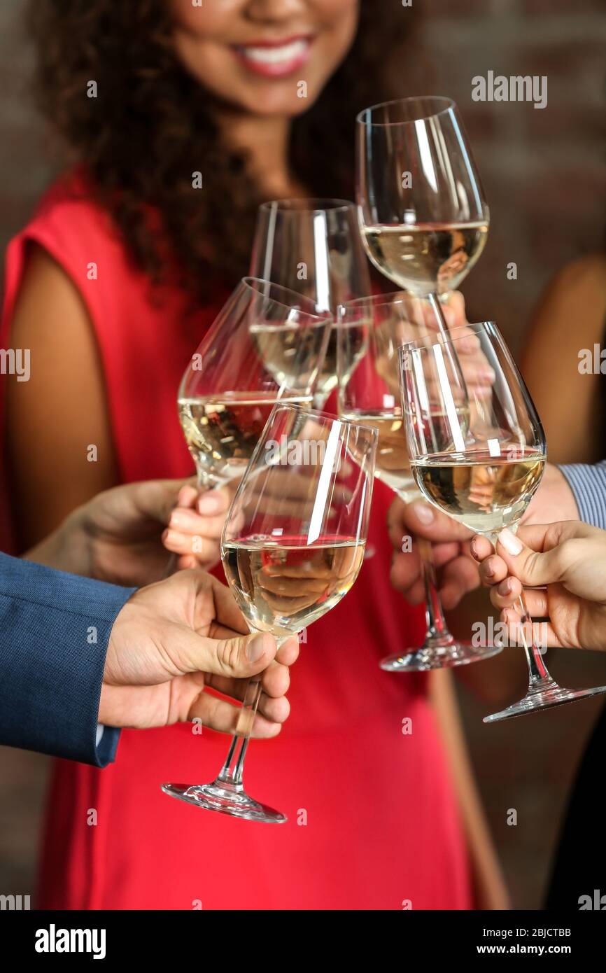 People toasting with glasses of white wine, closeup Stock Photo - Alamy