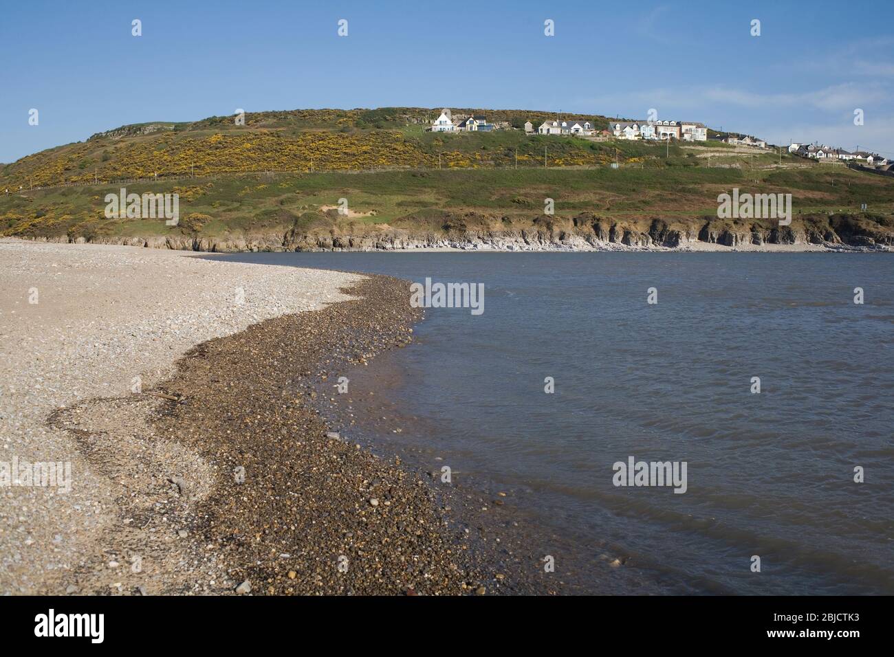 Newton beach near the mouth of the Ogmore river with the hillside village of Ogmore by sea Stock Photo