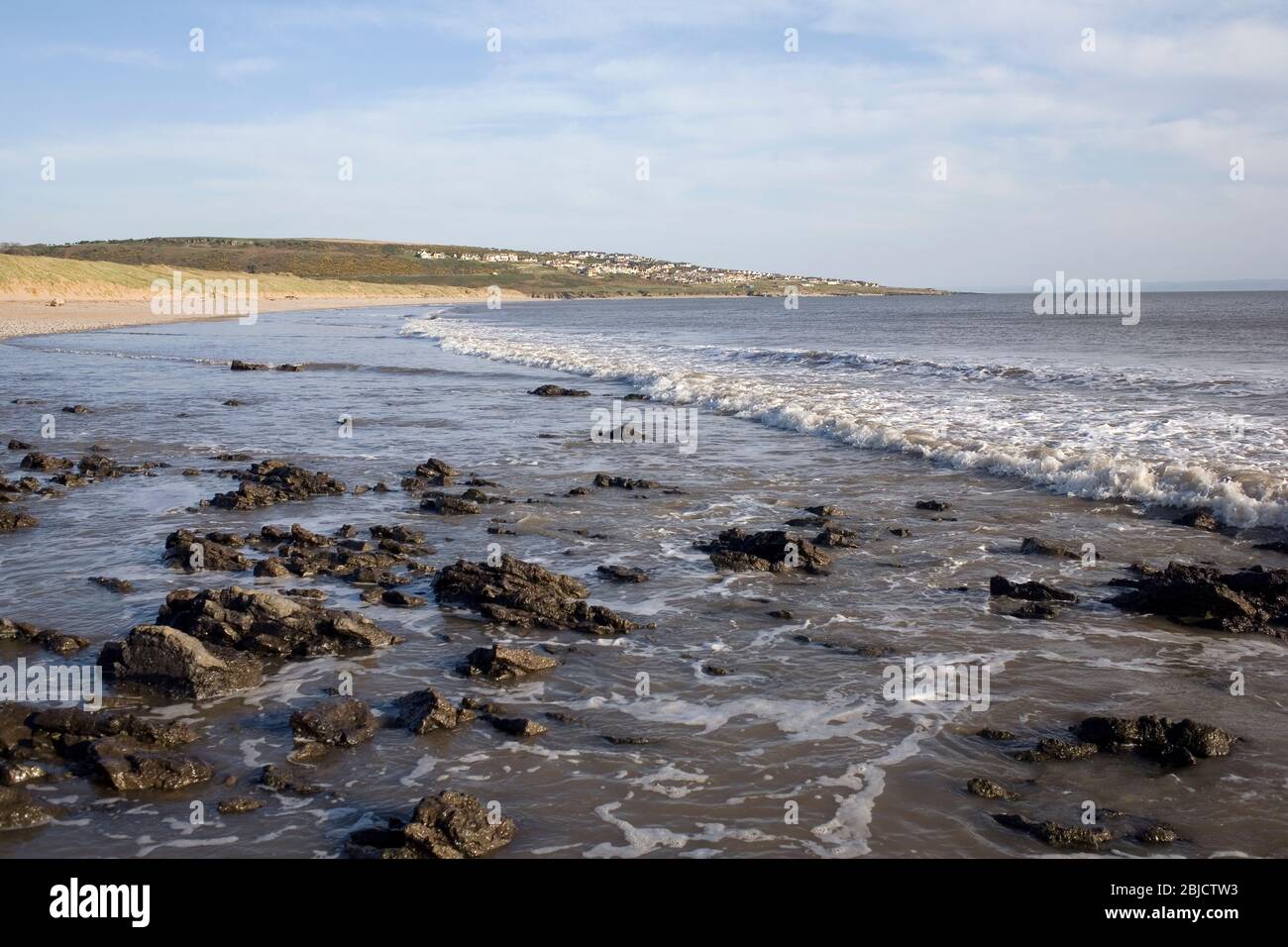 Newton beach at the end of the Black rocks looking towards Ogmore by Sea on a sunny spring evening Stock Photo